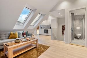 a living room with a couch and a table at Høyden Apartments in Bergen