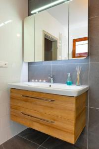 a bathroom with a sink and a mirror at MytoApartments in Mýto pod Ďumbierom