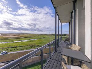 a balcony with chairs and a view of a field at Zwei Wasser - Alte Seefahrtschule in Wustrow