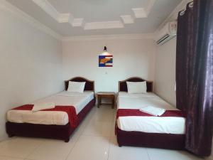 A bed or beds in a room at PAMA Hotel