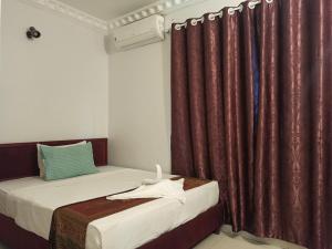 Un pat sau paturi într-o cameră la PAMA Hotel