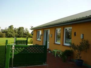 a house with a green fence in front of it at Ferienhof Petersen - Gastfreundschaft im hohen Norden in Großenwiehe +37 photos