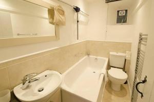 a white bathroom with a sink and a toilet at Woodland Crag Cottage, Grasmere in Grasmere