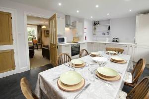 a kitchen and dining room with a table and chairs at Juniper Grasmere - Juniper Cottage, Grasmere in Grasmere