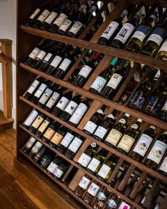 a bunch of bottles of wine on a shelf at The Three Horseshoes in Briston