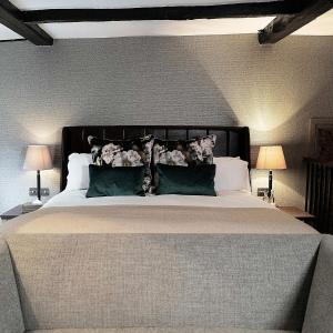a hotel room with two beds and a lamp at Hotel du Vin & Bistro Cambridge in Cambridge