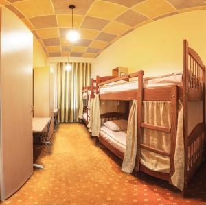 a room with two bunk beds and a room with a hallway at Comfort Park Hostel in Moscow