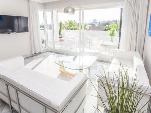 a living room with white furniture and a glass table at VACATION MARBELLA I El Dorado, Newly Renovated Flat, Beach, Golf lovers and Views in Marbella