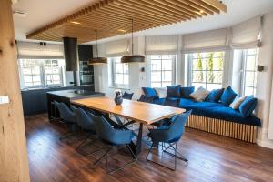 a living room with a blue couch and a wooden table at Willa pod Lanckoroną in Izdebnik