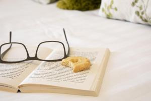 a donut and glasses sitting on a book at The Morley in Torquay