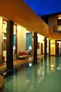 a villa with a swimming pool at night at Villa Capers in Colombo