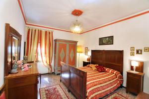 a bedroom with a bed and a dresser and a table at Casale Le Capanne in Cortona +42 photos