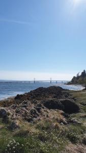 a view of the ocean with a bridge in the distance at Craigbreck Farm Cottage in North Kessock