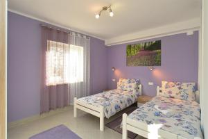 Postel nebo postele na pokoji v ubytování House Roza 2065
