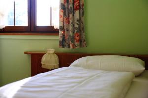a green bedroom with a bed and a window at Gasthaus Krone Märkt in Weil am Rhein
