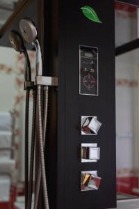 a black shower stall with a blow dryer at Versal Hotel in Maykop