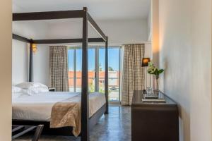 a bedroom with a canopy bed and a balcony at Hotel Solar Dos Mascarenhas in Vila Viçosa +28 photos