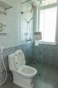 a bathroom with a toilet and a glass shower at Caly homestay in Da Lat +51 photos