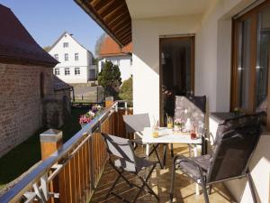a patio with a table and chairs on a balcony at Haus "Andrea" in Hilders