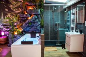 a bathroom with a sink and a shower at SECRET SUITE "Jungle" - Jacuzzi privatif - Gare RER C - Proche Paris in Brétigny-sur-Orge