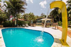 a swimming pool with a water fountain at Ecocharme Pousada do Marcilio in Fernando de Noronha