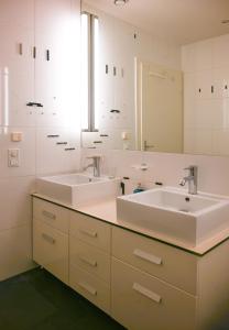 a bathroom with two sinks and a mirror at Royal Residence Hofburg in Vienna