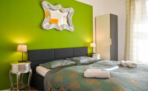zieloną sypialnię z łóżkiem z lustrem na ścianie w obiekcie Delightful Suite Hofburg w Wiedniu
