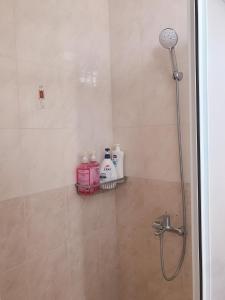 a bathroom with a shower with a glass door at Funny Eggs Guest House in Tainan
