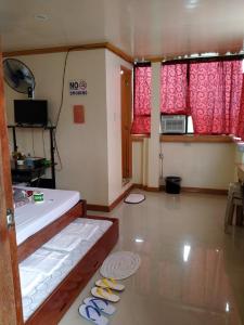 a room with a bed and some shoes on the floor at D'MESA Seacretlodge and Restaurant in Taytay +60 photos
