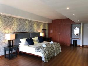 מיטה או מיטות בחדר ב-Highlands Eco Estate