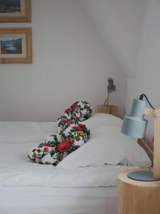 a white bed with two pillows on top of it at Zwijaczówka in Zakopane