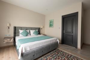A bed or beds in a room at Florya Novi Hotel