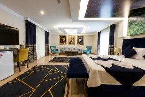a bedroom with a bed and a living room at Florya Novi Hotel in Istanbul