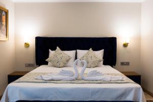 A bed or beds in a room at Florya Novi Hotel