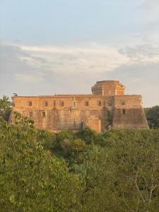 a castle on top of a hill with trees at Torre medievale Il Castellaccio in Civita Castellana