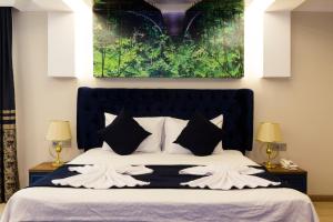 A bed or beds in a room at Florya Novi Hotel