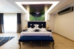 A bed or beds in a room at Florya Novi Hotel