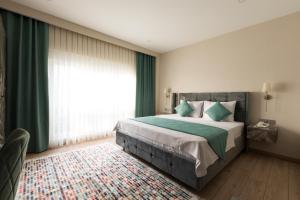 A bed or beds in a room at Florya Novi Hotel