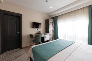 A bed or beds in a room at Florya Novi Hotel