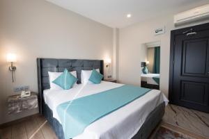 A bed or beds in a room at Florya Novi Hotel