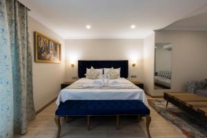 A bed or beds in a room at Florya Novi Hotel