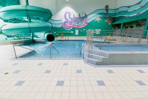 a water slide in a swimming pool in a building at Canad Inns Destination Centre Transcona in Winnipeg