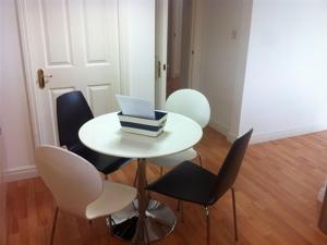 a white table with chairs and a laptop on it at Oceans 12 in Whitby