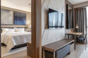 Postel nebo postele na pokoji v ubytování LK Design Hotel Florianópolis