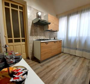 a kitchen with wooden floors and a stove top oven at Lina's House in Catania