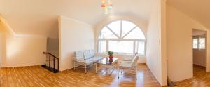 an attic living room with a table and chairs at Caly homestay in Da Lat