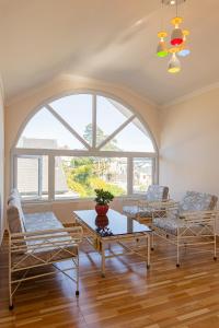 a living room with two chairs and a table and a window at Caly homestay in Da Lat