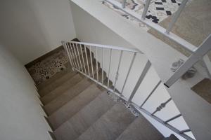 an overhead view of a staircase with white rails at La Guitgia Rooms in Lampedusa