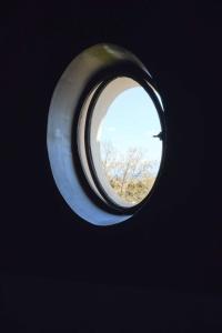 a circular window with a tree in the background at Casa Rubinacci in Naples