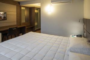 Ένα ή περισσότερα κρεβάτια σε δωμάτιο στο Hotel Laghetto Moinhos
